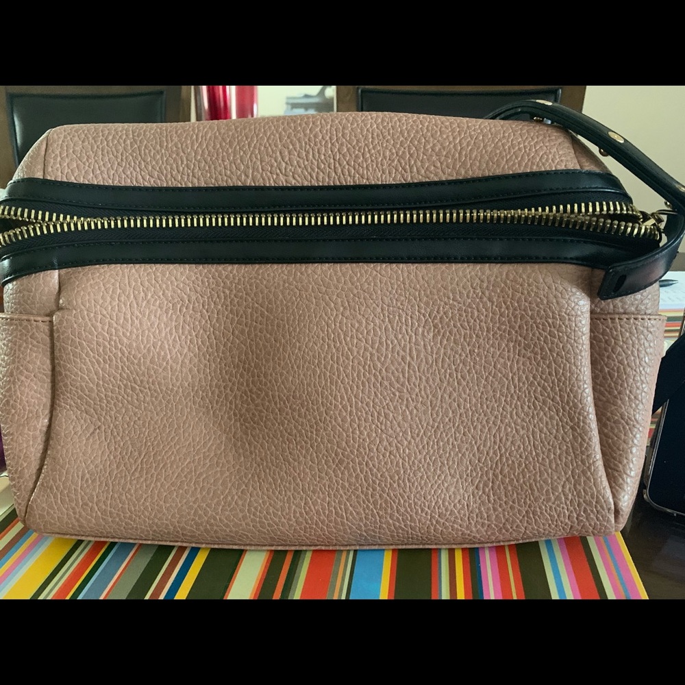 Women’s hand bag, cream and black in color.